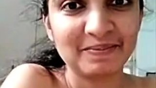 Horny busty indian milf strips nude to show round tits