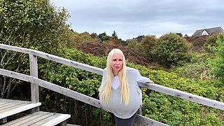 Blonde is flashing her big boobs in the outdoors