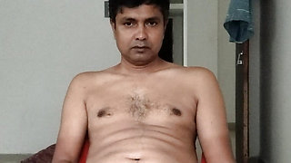 Nude sitting on chair.