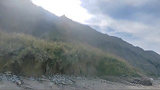 Perky MILF publicly gives a blowjob and fucks on a wild beach, ending it with pissing.