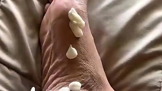 Brunette with foot fetish rubs big dick with her feet in POV