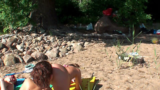 Four Tanned Stepsisters Lick Their Pussies in the Sun on the Beach