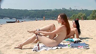 Nudist Teen With Brown Hair Is Sitting Down On The Beach