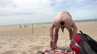 Dildo anal insertion on public beach