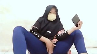 Indonesian hijab aunt wearing cucumber