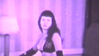 Vintage chick with old-fashioned hairstyle strips off her sexy lingerie